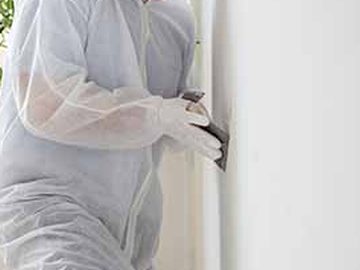 Worker finishing an interior wall during a remodel