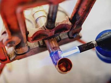 Welder working with a torch on a steel joint